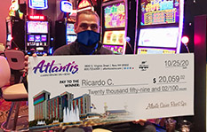 Jackpot winner Ricardo C. holding a check