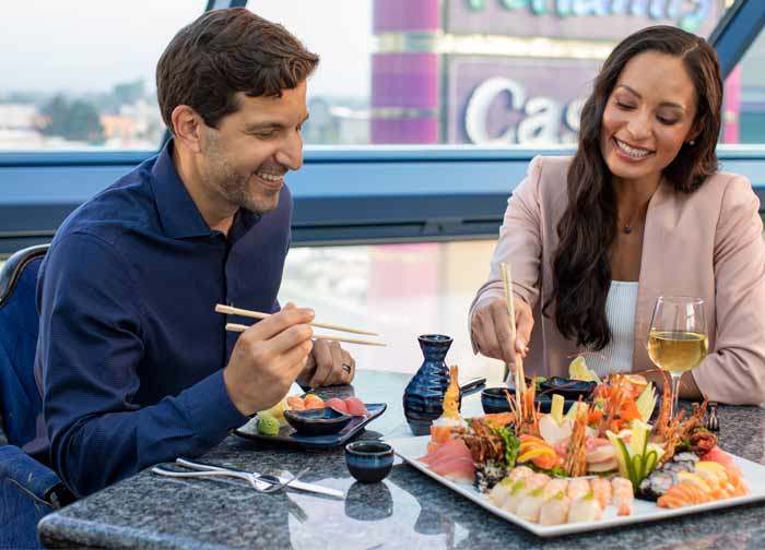 Couple eating sushi platter at Atlantis