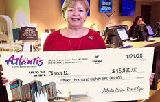 Jackpot Winner Diana S holding a check