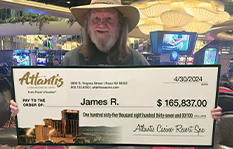 JP holding a winner&#39;s check of $165,837