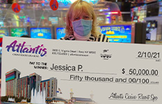 Jackpot winner Jessica P. holding a check