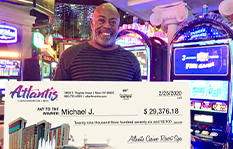 Jackpot Winner Michael J holding a check