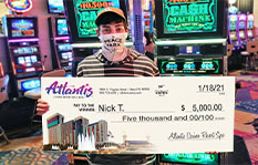 Jackpot winner Nick T. holding a check