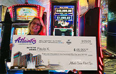 Jackpot winner Paula K. holding a check