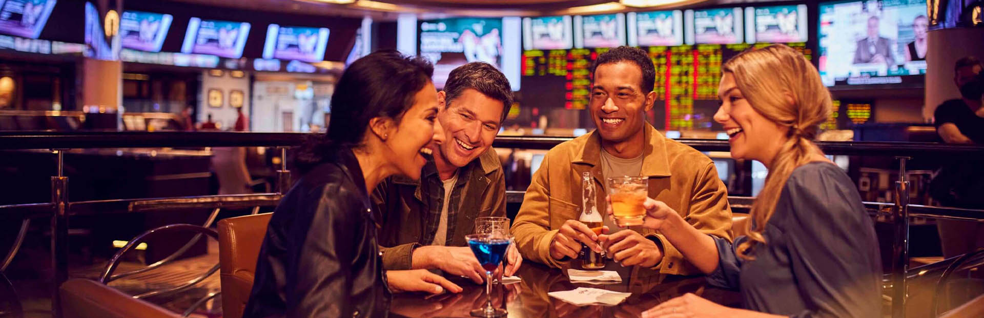 Four friends drinking at the Atlantis Race and Sports Book