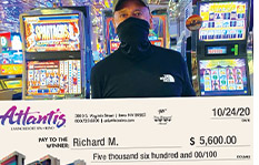 Jackpot winner Richard M. holding a check